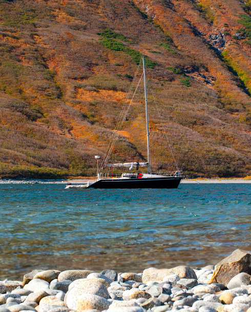 The north yacht on the bay of Pacific ocean in Kamchatka peninsula with mountains on background - Photo, Image