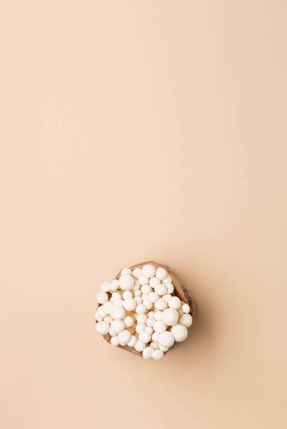 Fresh shimeji (white beech) mushrooms on pastel beige paper background. Superfood Trend fresh mushrooms. Top view, copy space. - Fotó, kép