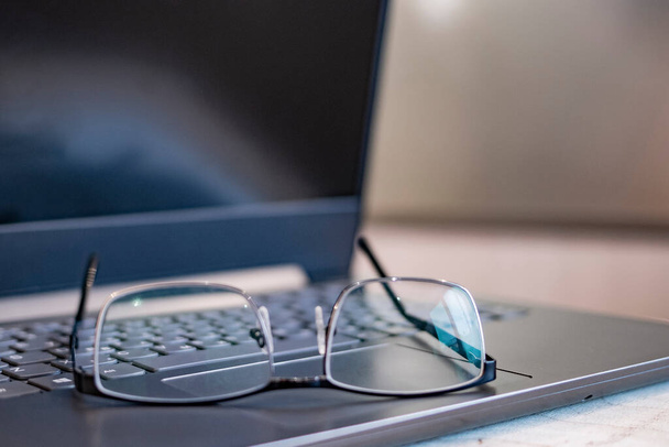 Beautiful glasses on the laptop. Out of focus. Blurred - Фото, зображення