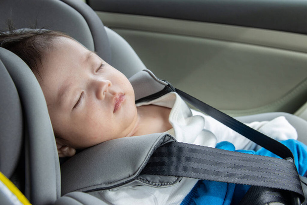 Local Lifestyle Asian Chinese baby boy asleep while in child safety car seat - Photo, Image