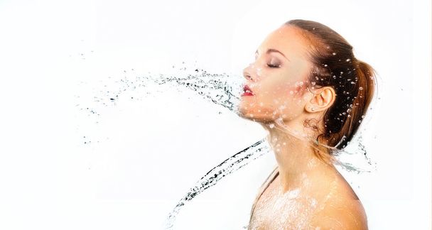 pretty woman with water splash. Beautiful model woman with a splash of water. Beautiful smiling girl underwater with fresh skin on blue background. Skin care, cleansing and moisturizing concept. Pretty face - Foto, immagini