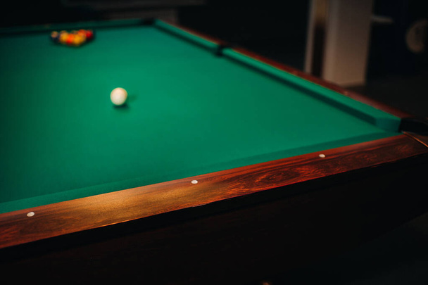 decorative billiard hole and green table with balls in the billiard club - Фото, изображение