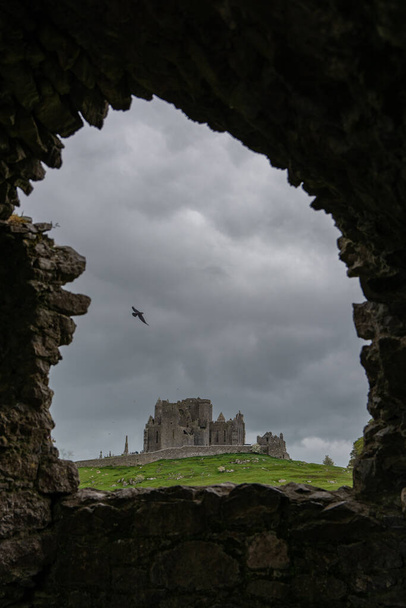 Mystic castle ruin in Ireland. Panoramic view of abandoned castle ruin in Ireland. Old castle ruin in Ireland. - Photo, Image