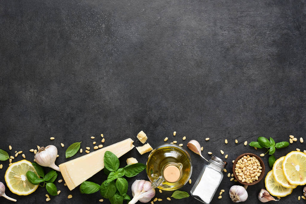 Ingredients for the pesto sauce: Parmesan, basil and pine nuts on a concrete background. Pesto sauce top view. - Foto, immagini