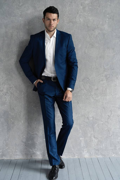 full length of handsome man wear blue suit isolated on grey background. - Фото, зображення