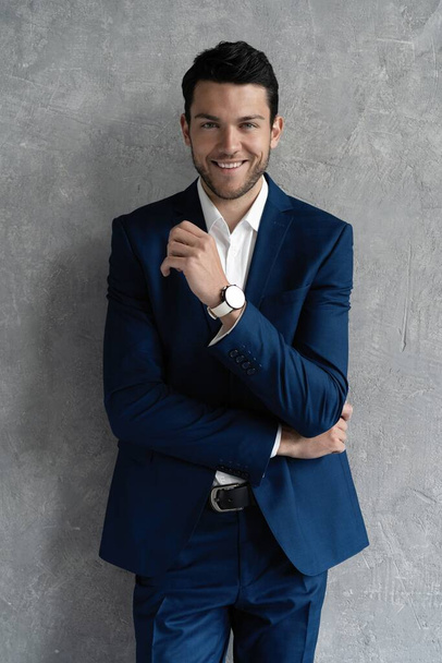 Handsome man wear blue suit isolated on grey background. - Фото, зображення