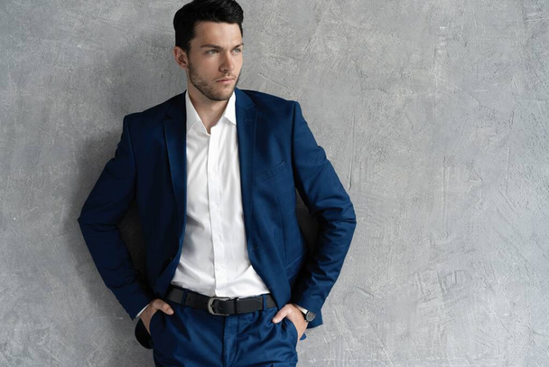 Handsome man wear blue suit isolated on grey background. - Fotoğraf, Görsel