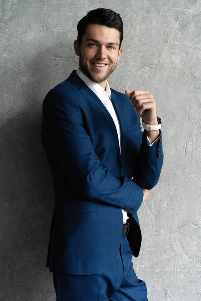 Handsome man wear blue suit isolated on grey background. - Fotó, kép
