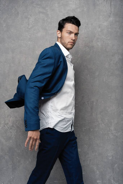 Handsome man wear blue suit isolated on grey background. - Fotoğraf, Görsel