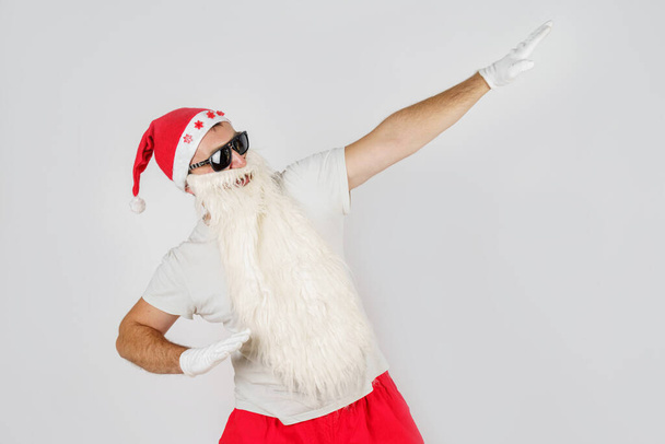 New Year and Christmas concept. Santa Claus makes gestures with his hands, raising them up. - Valokuva, kuva