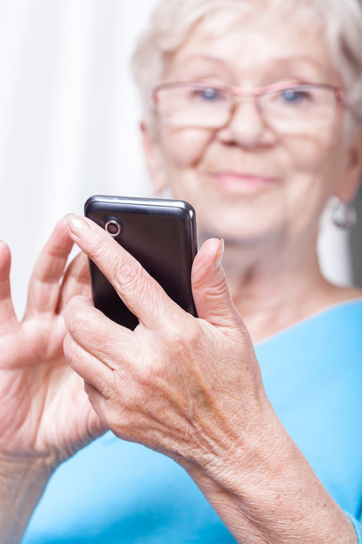 Senior lady using cellular phone application - Zdjęcie, obraz
