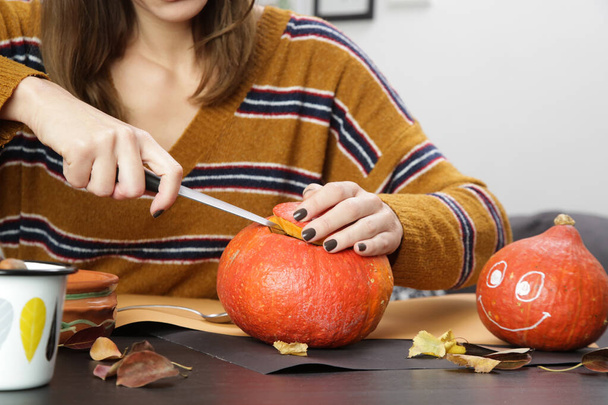 Young woman making Halloween decorations at home. Autumn season DIY craft. - Photo, Image