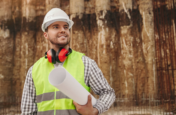 Confident construction worker with blueprint - Фото, зображення