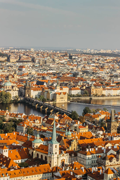 Aerial postcard view of Prague,Czechia. Prague panorama.Beautiful sunny landscape of the capital of Czechia.Amazing European cityscape.Red roofs,bridges over Vltava river.Travel urban scenery - Foto, Imagem
