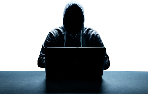 Hacker prints a code on a laptop keyboard to break into a cyberspace - Photo, Image