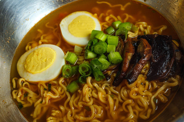 Korean cuisine ramen noodle soup with mushrooms and hard boiled eggs - Photo, Image