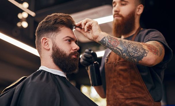 Barber stylish hair of customer - Photo, Image