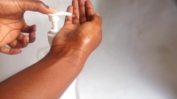 Hand squeezing hand sanitizer liquid gel on hand footage. Showing the colorless alcohol sanitizing gel video clip. African American. Diversity, concept. Ethnicity. Coronavirus hygiene concept. Copyspace. - Footage, Video