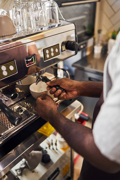 Male hands using professional coffee machine in cafe - Photo, image