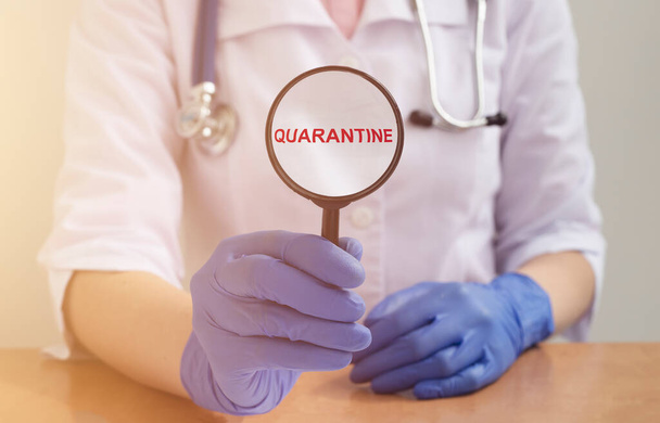 word QUARANTINE on paper in hands of doctor in protective gloves over white background. medical lockdown concept - Zdjęcie, obraz