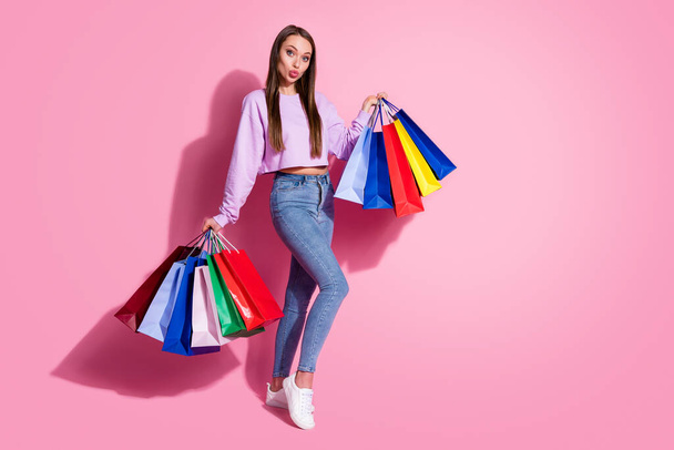 Full size photo of dreamy flirty girl shopping center client hold many bags send air kiss wear lilac style stylish trendy jumper denim jeans isolated over pastel color background - Fotoğraf, Görsel