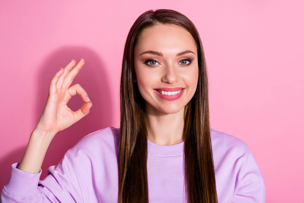 Closeup photo of attractive cheerful lady show okey symbol good mood expressing agreement approve quality expert wear casual purple sweater isolated pink pastel color background - Fotografie, Obrázek
