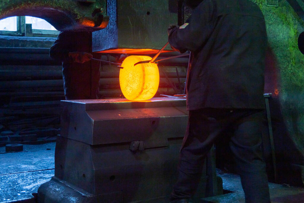 közeli kép forró acél szabad kovácsolási folyamat nagy mechanikus kalapács gép - Fotó, kép