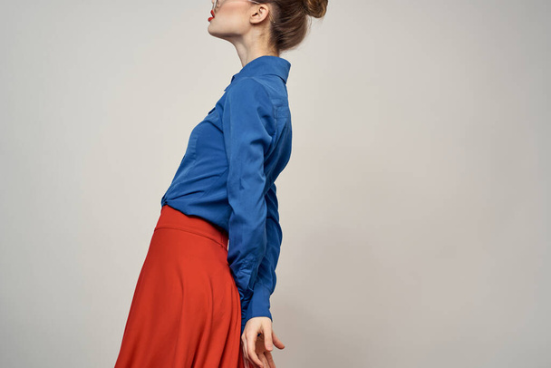 woman model in blue shirt and red skirt glasses beautiful face makeup studio - Valokuva, kuva