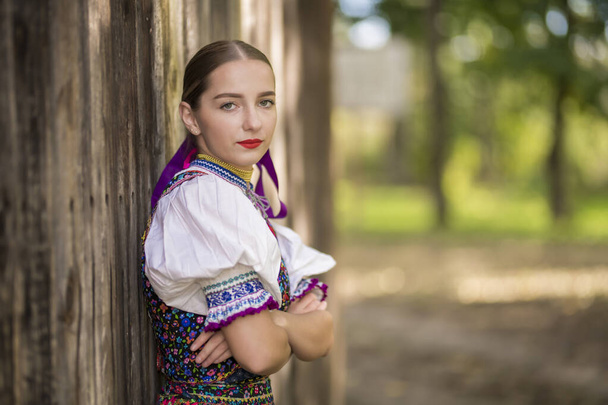 Young beautiful slovak woman in traditional costume. Slovak folklore. - Fotó, kép