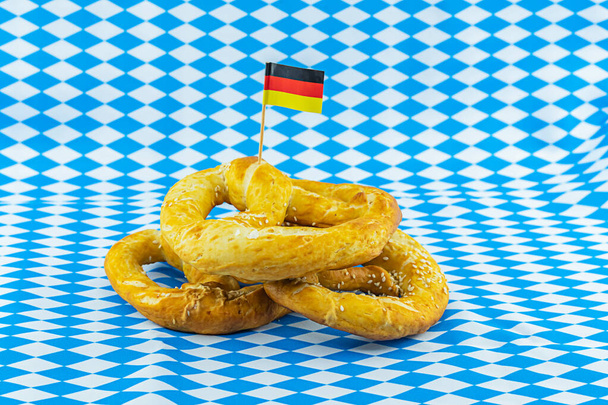 Német perec Németország zászlajával, az Oktoberfest sörfesztivál szimbóluma - Fotó, kép