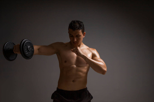 man with naked torso doing dumbbell arm exercise, sport concept - 写真・画像