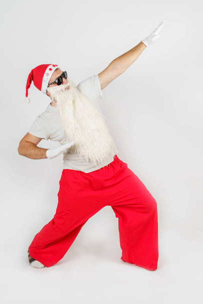 New Year and Christmas concept. Santa Claus makes gestures with his hands, raising them up. - Fotografie, Obrázek