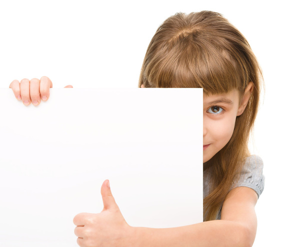 Little girl is looking out from the blank banner - Photo, image