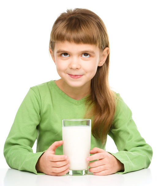 Cute little girl with a glass of milk - Foto, immagini