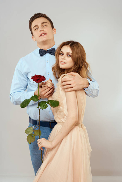 Young couple hugs romance dating lifestyle relationship light background red rose - Photo, image