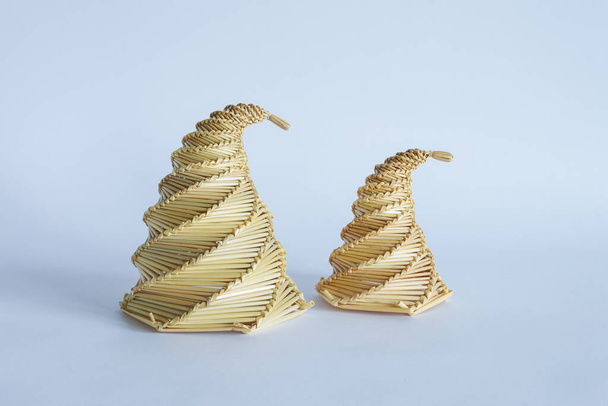 Sculpture from straw on a light background. Decoration. Souvenir. Straw products - Photo, Image