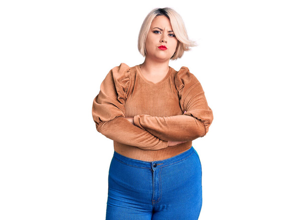 Young blonde plus size woman wearing casual sweater skeptic and nervous, disapproving expression on face with crossed arms. negative person.  - Foto, Bild