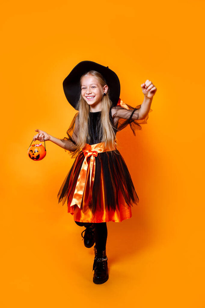 Young girl in witchcostume goes trick or treating - Fotó, kép