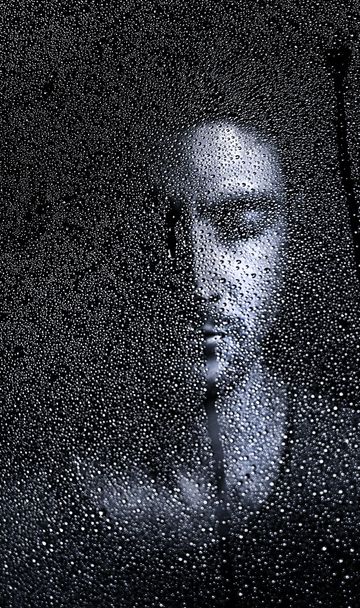 Hombre visto a través de una ventana lluviosa
 - Foto, Imagen