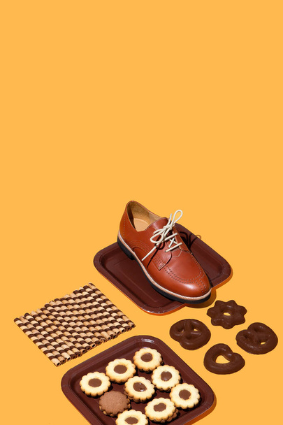 Stylish chocolate isomertric composition. Cookies and vintage  shoes. Fashion funny sweet christmas holiday. Winter time concept art. Copy space - Photo, Image