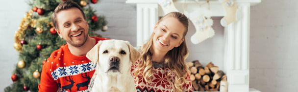 happy couple near dog and christmas tree at home, banner - Photo, Image