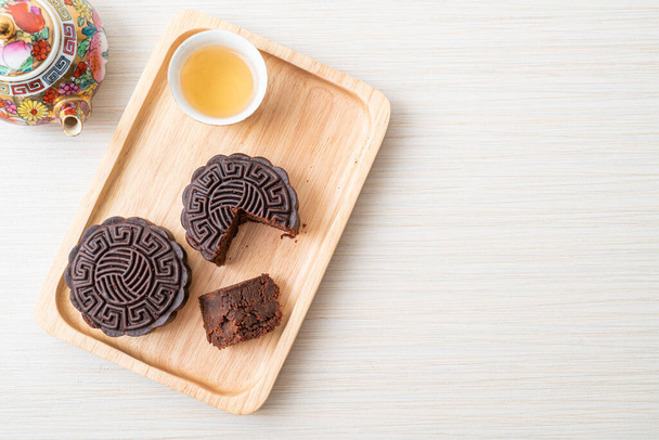 Chinese moon cake dark chocolate flavour on wood plate - Foto, Imagem