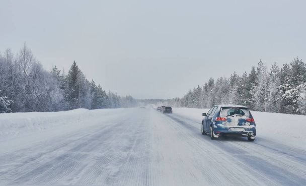 We drive in a magnificent winter landscape with icy roads and beautiful views. The road goes from Lule on the coast of Norrbotten to Jokkmokk in Swedish Lapland and on to a small lake far out in the wilderness - Photo, Image