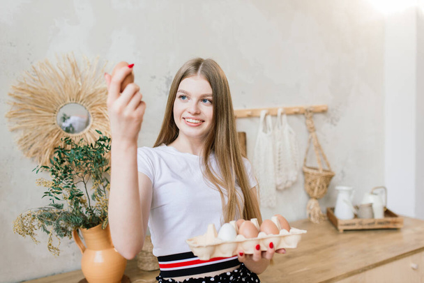 Healthy eating concept. Beautiful young woman with eggs at kitchen. - Φωτογραφία, εικόνα