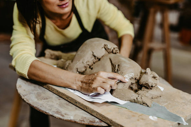 kobieta robi drewniane koło na ciemnym tle studio - Zdjęcie, obraz