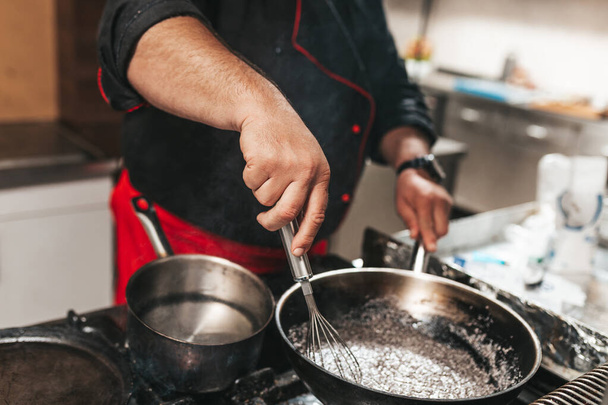 Professional chef in kitchen restaurant preparing sauce. - Photo, Image