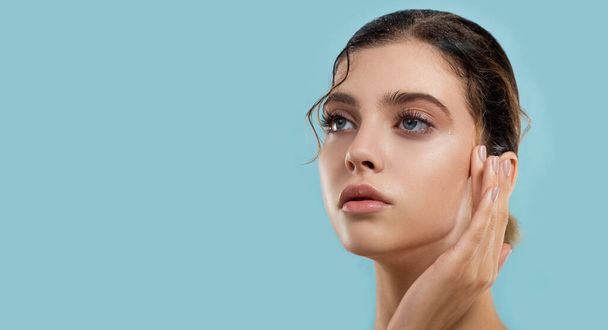 Beautiful young  woman with fresh clean perfect skin cares about her wet moisture skin. Portrait of beauty model with natural make up. Spa, skincare and wellness. - Foto, immagini