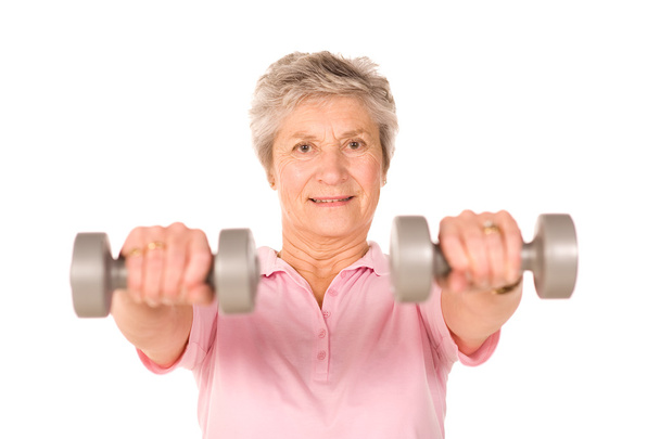 Mature lady lifting weights - Фото, изображение