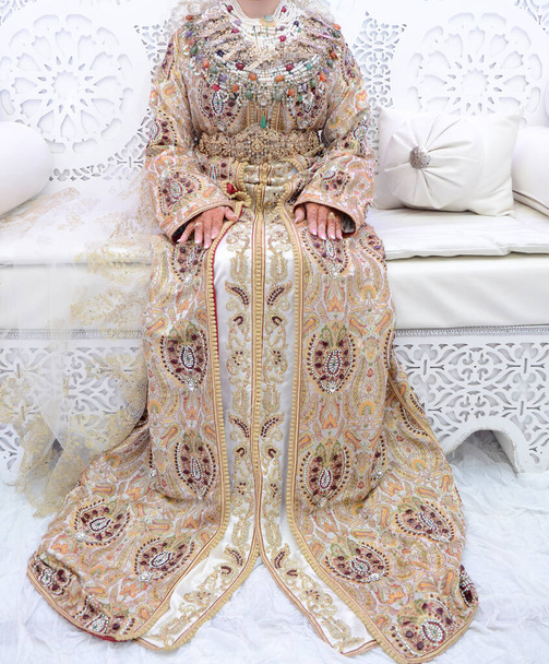 The traditional dress of the Moroccan bride. Beautiful bride wearing Moroccan caftan and precious jewelry - Photo, Image