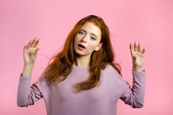 Cute girl showing bla-bla-bla gesture with hands and rolling eyes isolated on pink background. Empty promises, blah concept. Lier. - Photo, Image